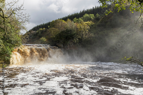 Crammel Linn waterfall on the Norhumberland Cumbria border, UK in full flow photo
