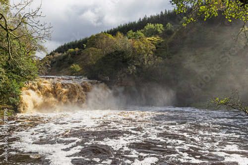 Crammel Linn waterfall on the Norhumberland Cumbria border, UK in full flow photo