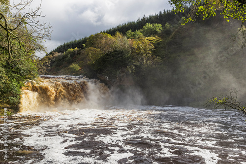 Crammel Linn waterfall on the Norhumberland Cumbria border, UK in full flow photo