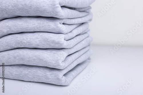 Stack of blank colorful sweatshirts closeup photo