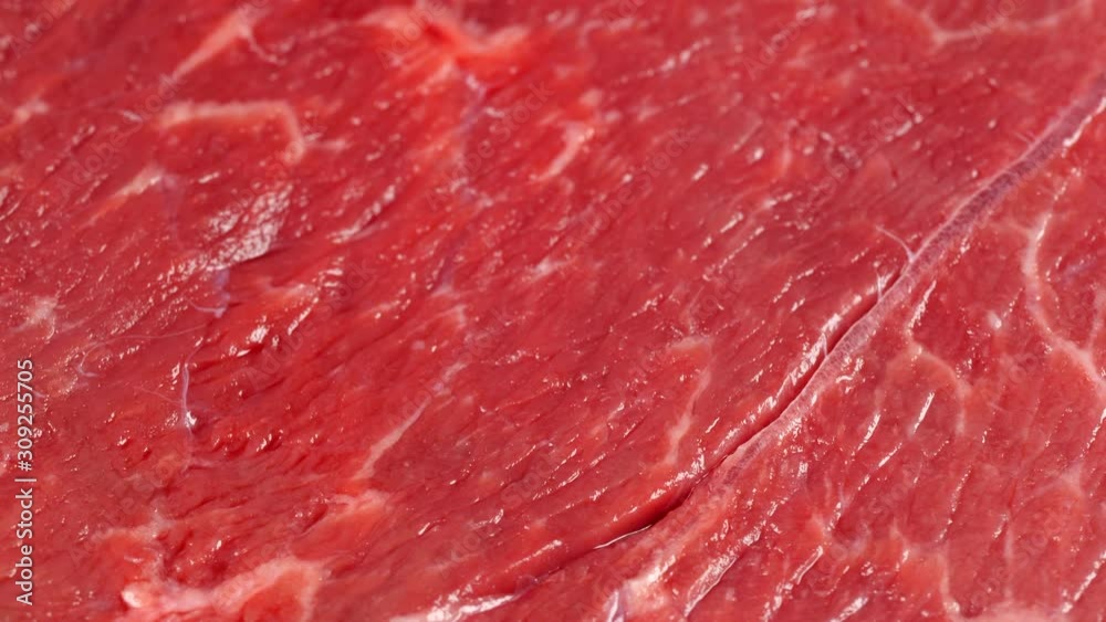 Sliding over marble beef, low angle. Meat texture, background. Surface of uncooked steak. Dolly shot. 4K 422 10 bit Sliding over marble beef, low angle. Meat texture, background. Surface of uncooked steak. Dolly shot. 4K 422 10 bit