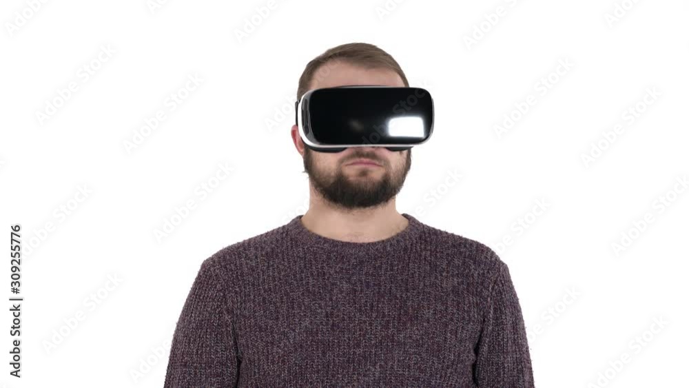 Close-up of an excited young man in virtual digital glasses looking up and down. Man is turning his head to the sides. 3d cyberspace simulation concept. Isolated, on white background Close-up of an excited young man in virtual digital glasses looking up and down. Man is turning his head to the sides. 3d cyberspace simulation concept. Isolated, on white background