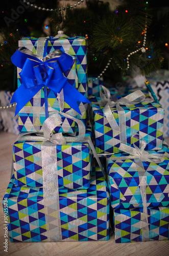  gifts in beautiful packaging with a blue ribbon. Boxes packed in bright paper © Yuliya