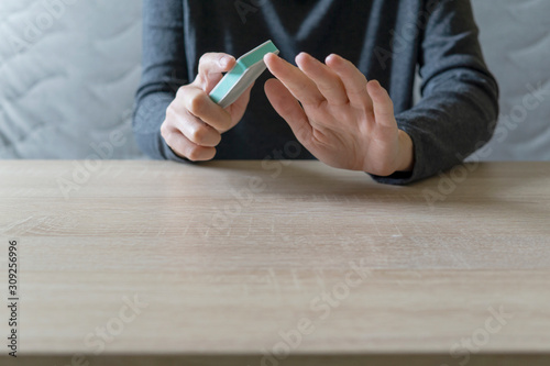 Woman doing the manicure. Removing the polish and putting on the cream. Woman that care his hands. Style concept.