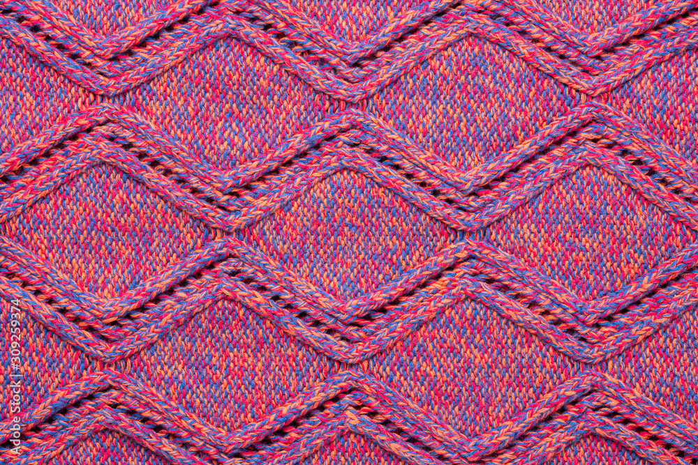 Knitted sweater texture. Pink melange rhombus pattern. Background. Copy space