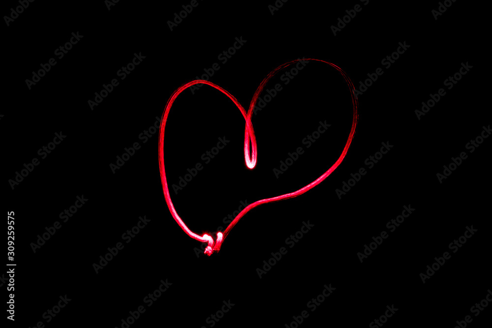 Red heart on a black background, love