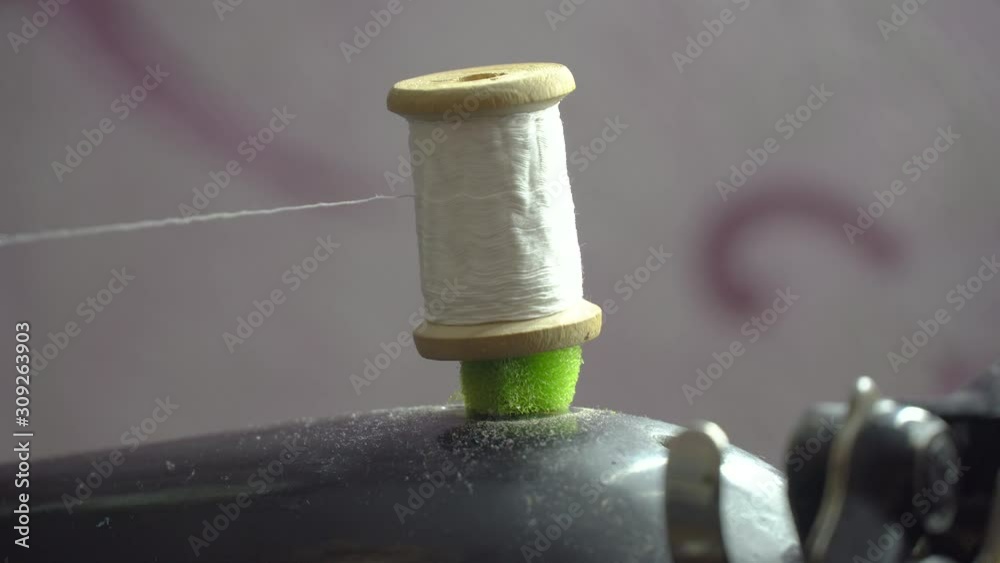 Stockvideon Thread is Wound on a Robbin. Closeup of a Spool with Thin