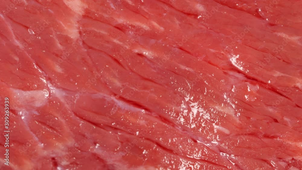 Tracking over angus marbled beef. Meat texture close up, macro. Surface of uncooked steak. Slider shot. Top view. 4K 422 10 bit Tracking over angus marbled beef. Meat texture close up, macro. Surface of uncooked steak. Slider shot. Top view. 4K 422 10 bit