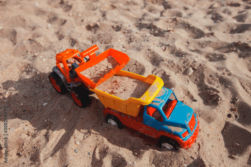 Childrens plastic toys in the sand. Childrens games Childrens plastic toys in the sand. Childrens games