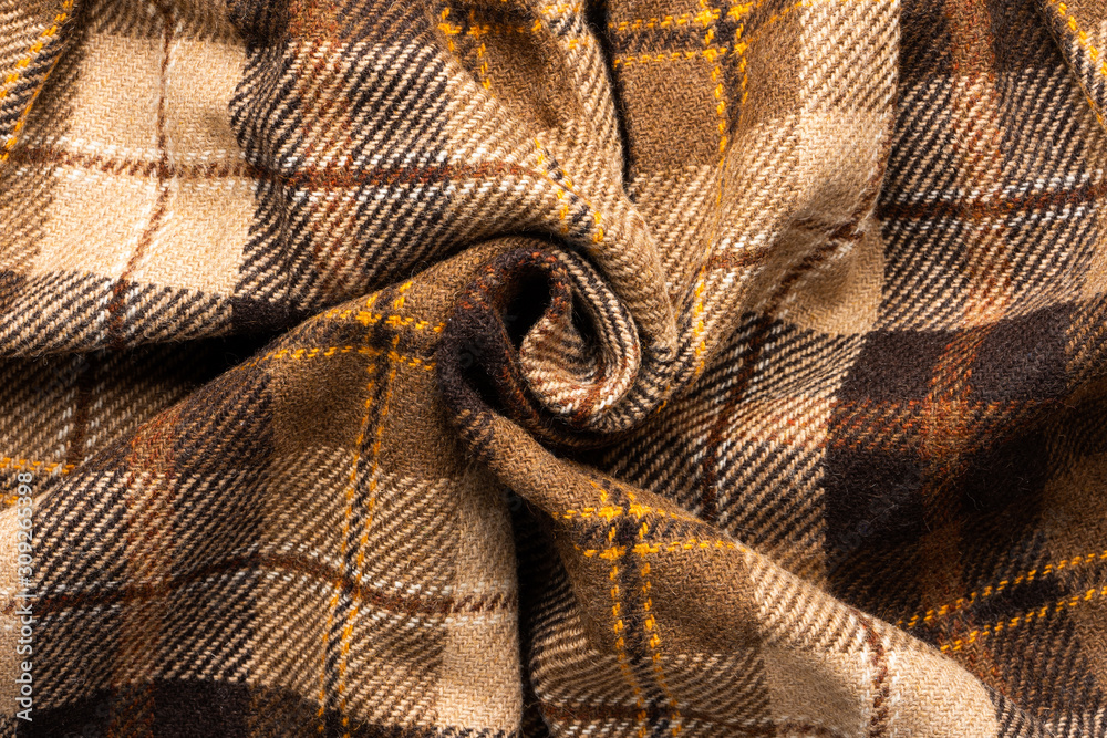 Brown checked fabric. Scottish wool. Fabric for coat plaid suit. Close-up. Background Brown checked fabric. Scottish wool. Fabric for coat plaid suit. Close-up. Background