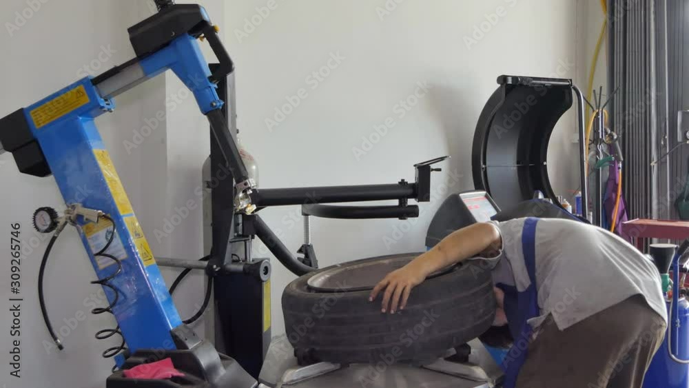 Asian technicians are repairing, maintenance and change tire in garage. Asian technicians are repairing, maintenance and change tire in garage.