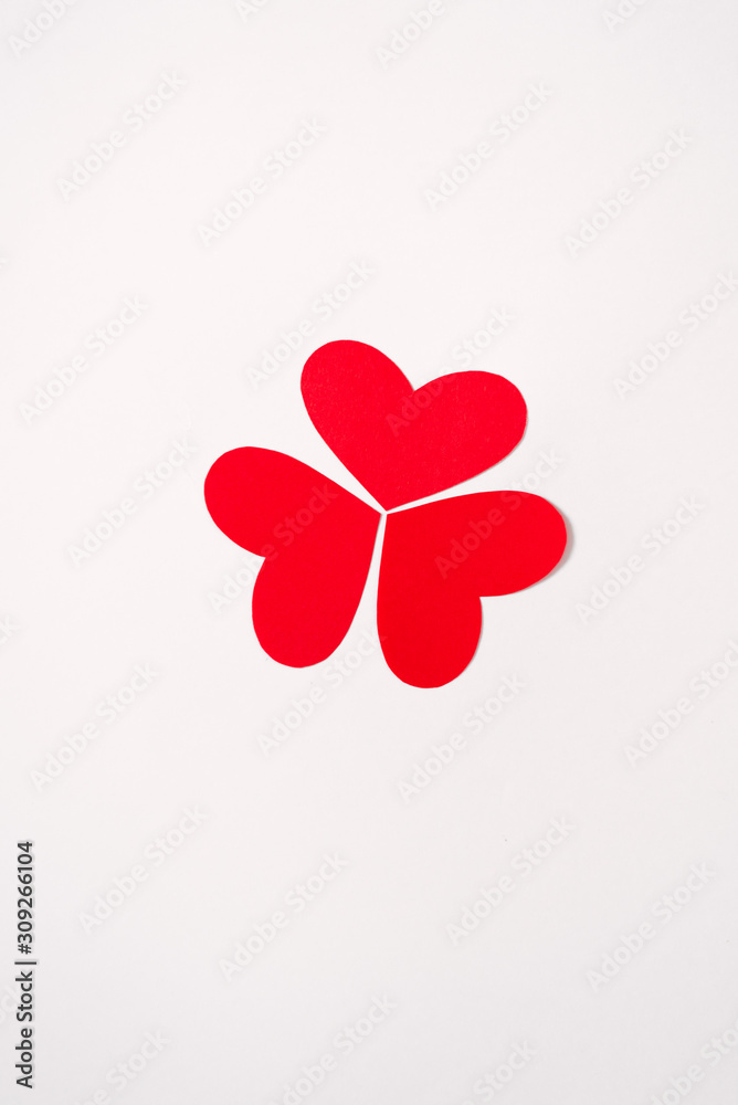 Red and pink hearts are folded into a figure or pattern. Festive greeting card for Valentine's Day. Minimalism and originality Red and pink hearts are folded into a figure or pattern. Festive greeting card for Valentine's Day. Minimalism and originality