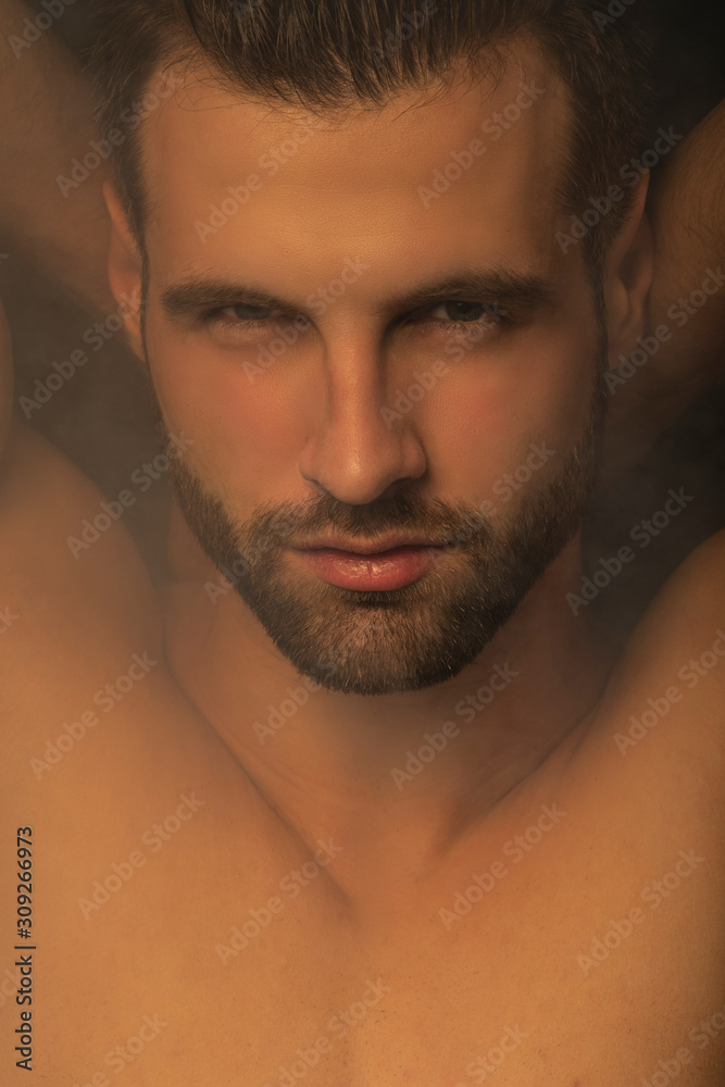 Handsome sport sexy stripped guy portrait for cosmetics and fitness on isolated black background