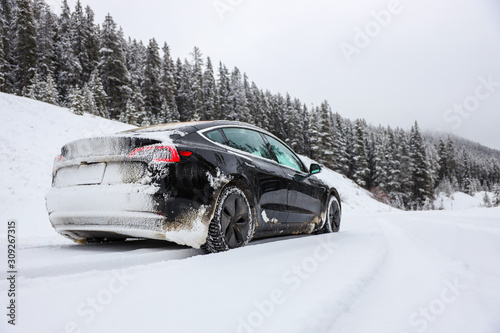 Electric car driving, mountains snow