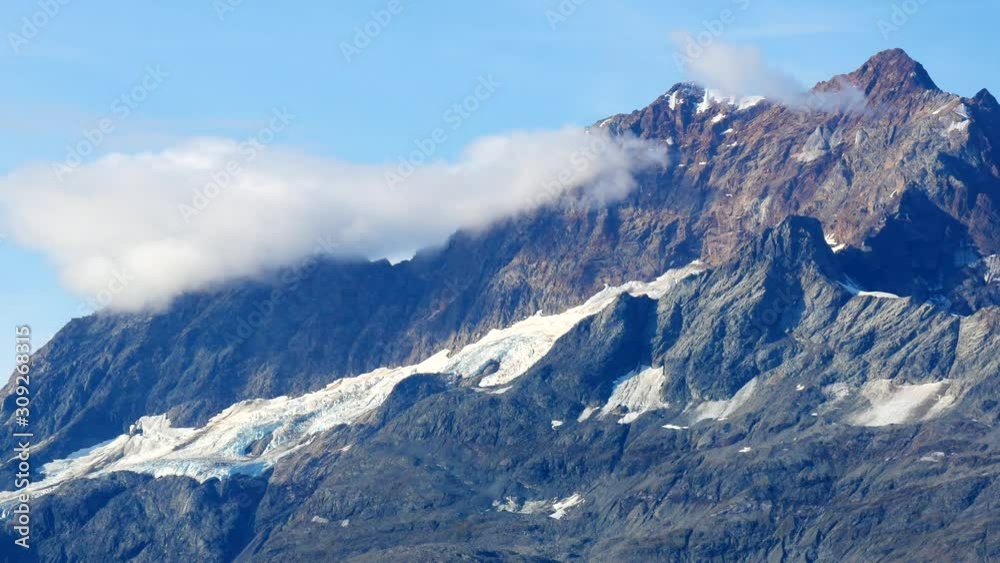 Close up view of snow capped mountains in Alaska. Glacier Bay National Park during sunny day Close up view of snow capped mountains in Alaska. Glacier Bay National Park during sunny day