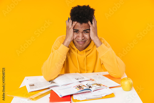 Desparate african teenager boy studying photo
