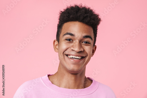Fotografija Portrait of a smiling african teenager boy wearing pullower