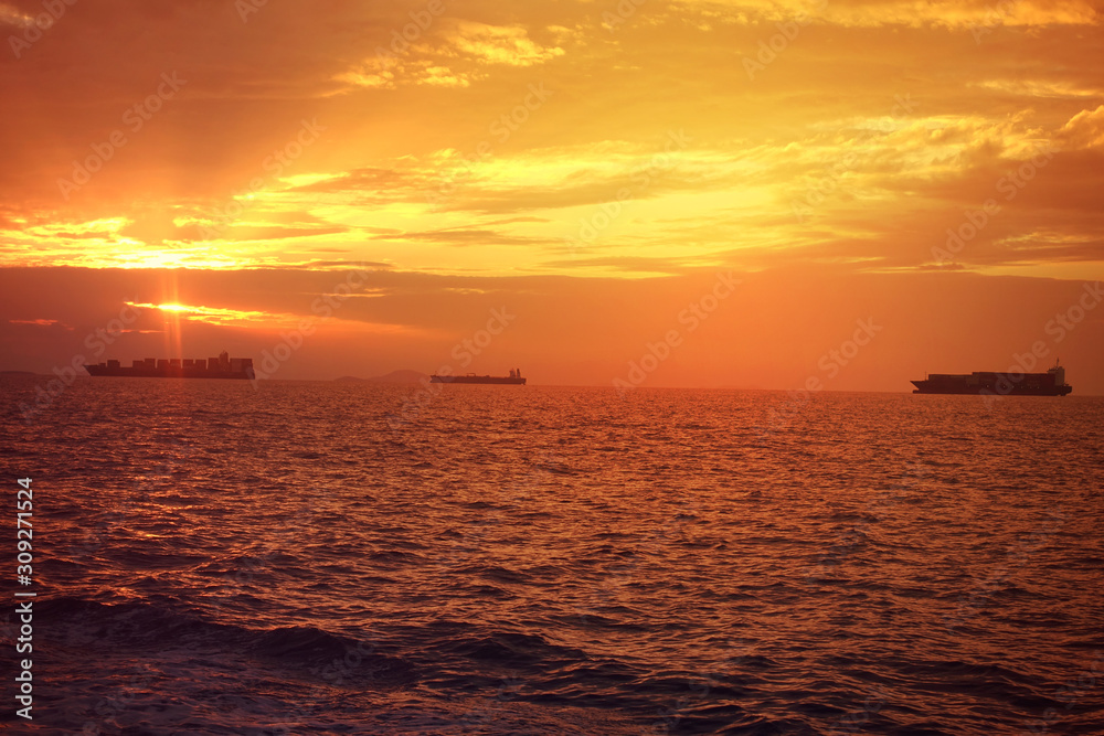 Romantic sunset over the Aegean sea with beautiful golden colours and clouds as seen from cruising yacht in Cyclades isalands, Greece Romantic sunset over the Aegean sea with beautiful golden colours and clouds as seen from cruising yacht in Cyclades isalands, Greece