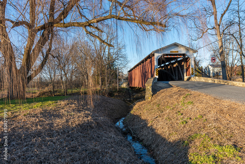 Neff's Mill Covered Bridge Crossing Pequea Creek in Lancaster County, Pennsylvania photo