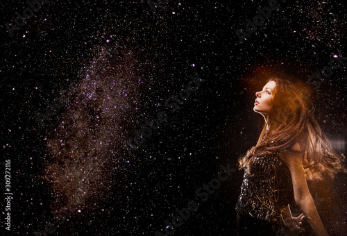 Woman in Cosmic space collage. Stars in Milky Way Galaxy as a background 