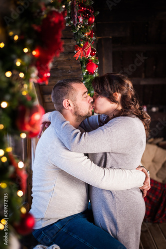 Portrait of a young couple in the living room at Christmas.