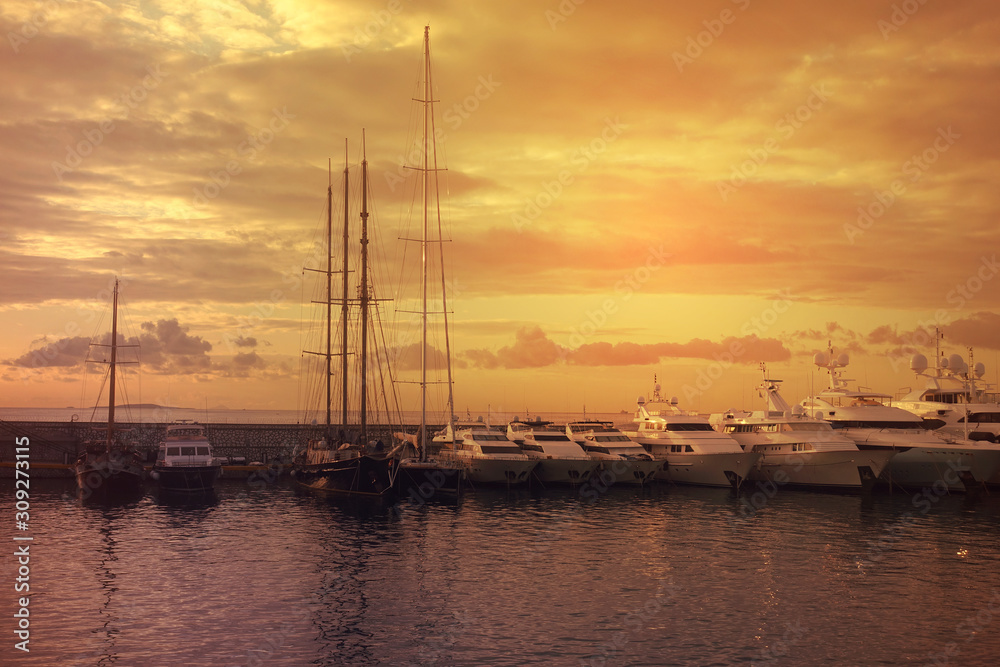 Beautiful sunset with golden colours and clouds in famous round port and marina of Zea or Passalimani, Piraeus, Attica, Greece