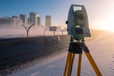 Theodolite. Work as a Surveyor. Topographic measurements. Tapography. Career Tapograph. Theodolite on a tripod on the background of the winter city. Winter city. Saint Petersburg. Russia.
