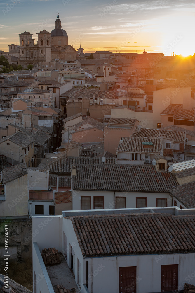 Fototapeta premium Toledo is an ancient city set on a hill above the plains of Castilla-La Mancha in central Spain. The capital of the region. Vertical in sunset.