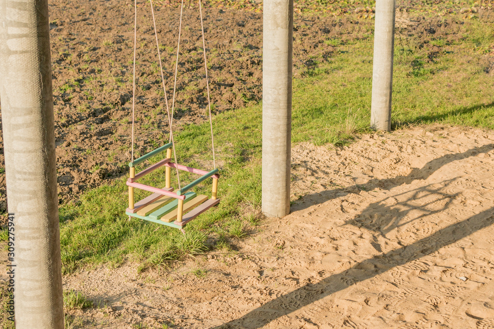 Children's swing hanging freely in the yard
