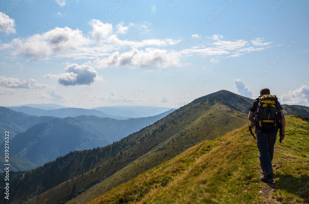 Young man on the way to the top of the mountain, Carpathians Ukraine