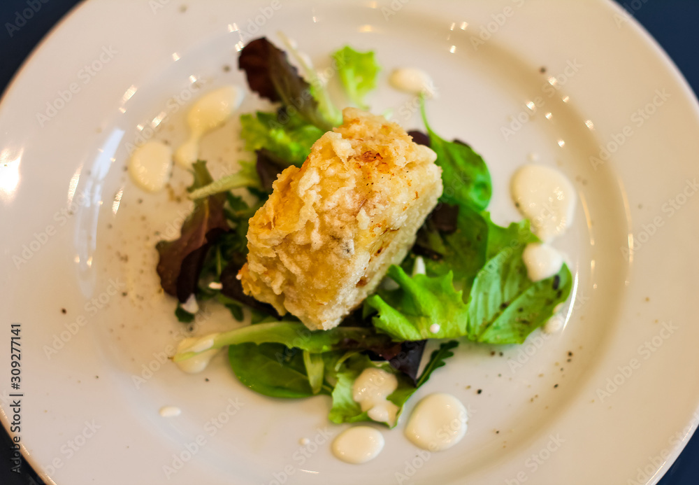 top view of fried roll stuffed with mozzarella with lettuce leafs, cream cheese and pepper, italian restaurant top view of fried roll stuffed with mozzarella with lettuce leafs, cream cheese and pepper, italian restaurant