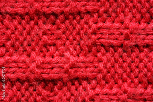 The texture of a knitted sweater. Red pattern. Facial surface. Background. Copy space © v_sot