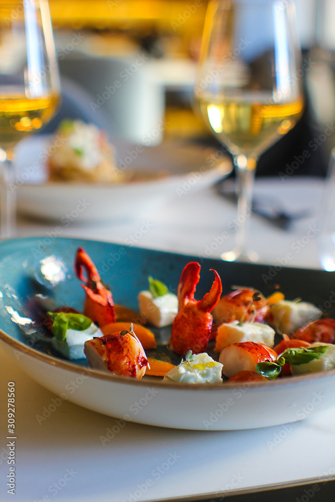 detail of haute cuisine dish with a plating of lobster pieces, cherry tomatoes and buffalo mozzarella. In a luxurious Italian restaurant