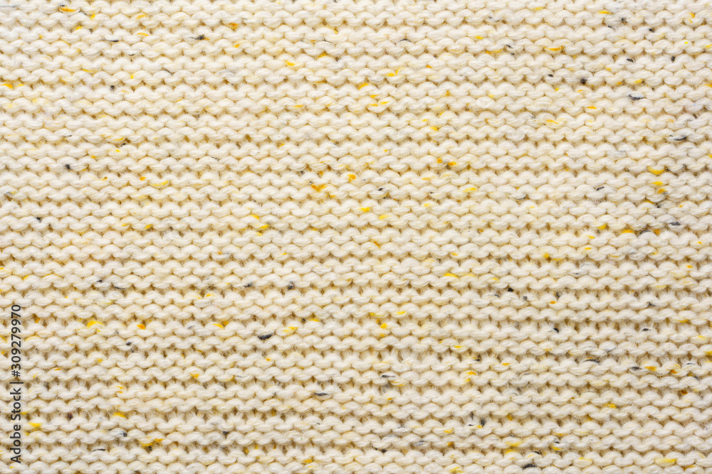 The texture of a knitted sweater. Beige pattern. Inside. Background. Copy space The texture of a knitted sweater. Beige pattern. Inside. Background. Copy space