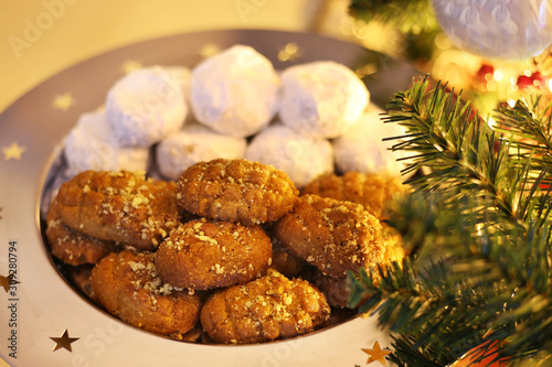 greek melomakarona and kourabies - traditional Christmas cookies with honey and nuts and sugar buns - night home Christmas scene