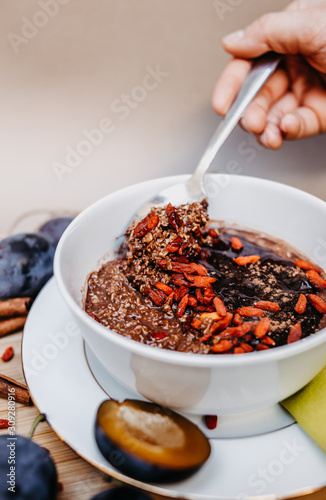 Healthy vegan oatmeal with goji and cocoa.
