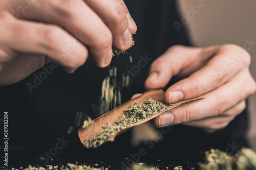 Fotografía Close up marijuana joint with lighter