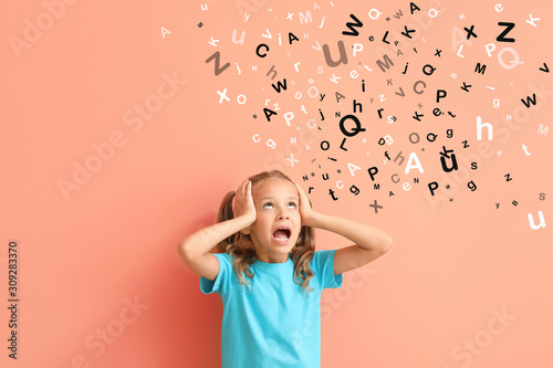 Surprised little girl on color background photo