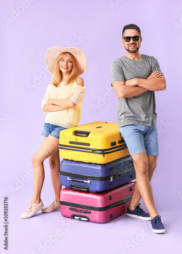 Couple with suitcases on co...