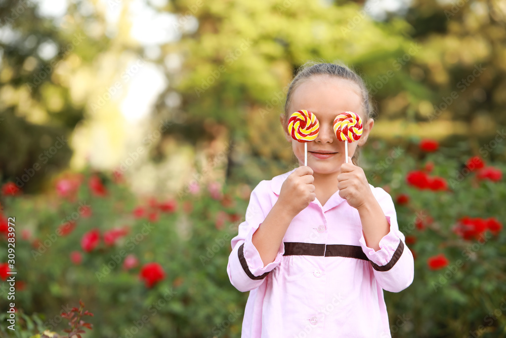 Cute little girl with sweet lollipops outdoors Cute little girl with sweet lollipops outdoors