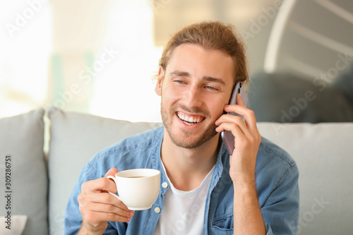 Handsome man with cup of co...