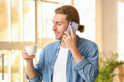 Handsome man with cup of co...