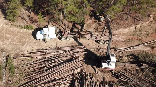 Aerial of a crane loading a logging truck with timber