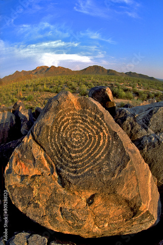 Concentric Circle Petroglyph and wide angle view of desert landscape. Petroglyphs made by the Hohokam people can be seen in Saguaro National Park in Tucson, Arizona photo