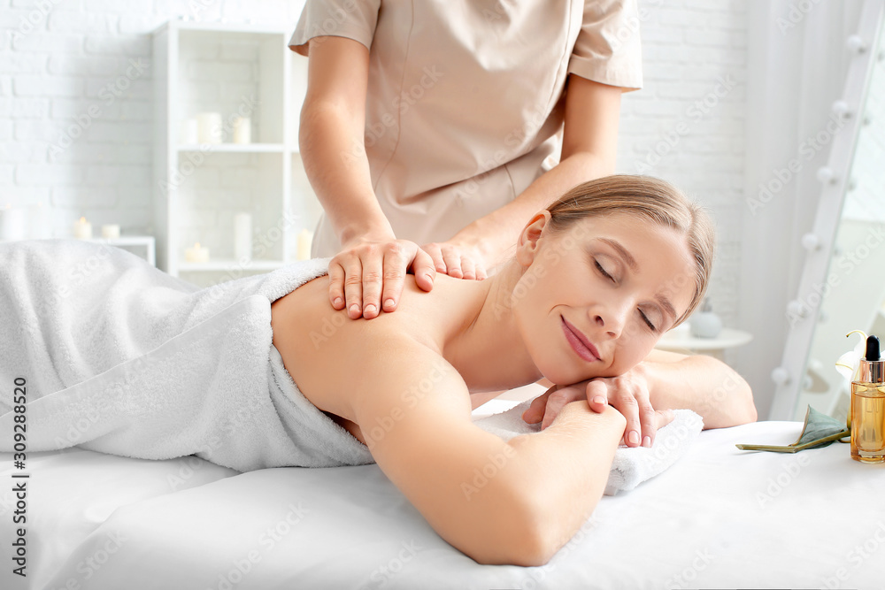 Fototapeta premium Beautiful woman receiving massage in spa salon