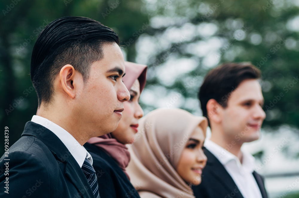 Group of young executive people in formalwear standing over shallow depth of field background Group of young executive people in formalwear standing over shallow depth of field background