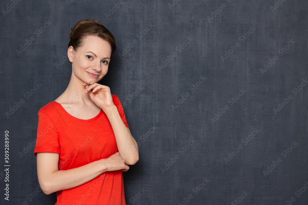 Portrait of happy focused young woman touching chin with one hand Portrait of happy focused young woman touching chin with one hand