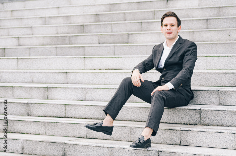 frustrated and depressed expression face,young business man sitting on stairs frustrated and depressed expression face,young business man sitting on stairs