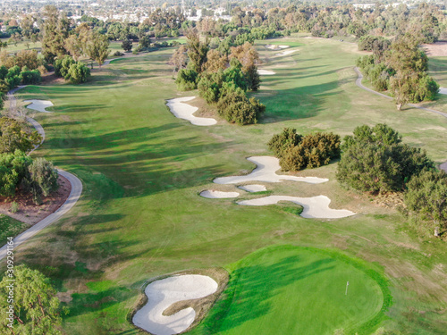 Fototapeta Naklejka Na Ścianę i Meble -  Aerial view over golf field. Large and green turf golf course in South California. USA