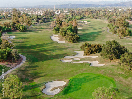 Aerial view over golf field. Large and green turf golf course in South California. USA © Unwind